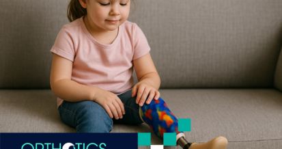 A little girl with a prosthetic leg is sitting on a couch