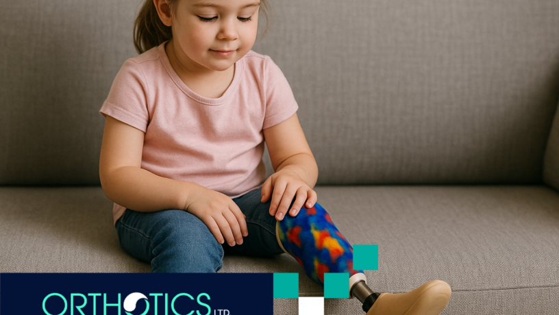 Pediatric Prosthetics - Featured A little girl with a prosthetic leg is sitting on a couch