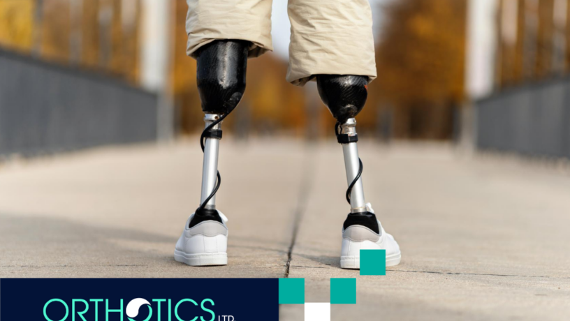 An amputee with a prosthetic legs is standing outdoors