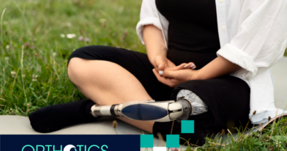 An amputee with a prosthetic leg sitting on the grass