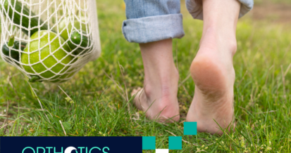 A person walking on the grass barefoot