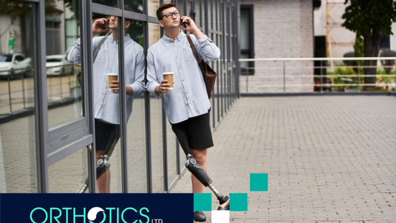 Returning to Work with a Prosthetic Limb - featured An amputee with a prosthetic limb is on the phone while holding a cup of coffee