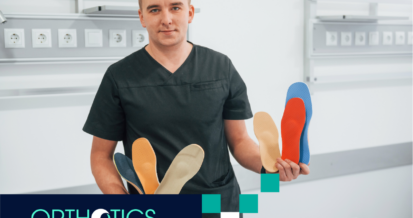 A guy holding shoe insoles