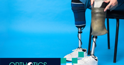 A perosn wearing prosthetics sitting on a chair with a blue background